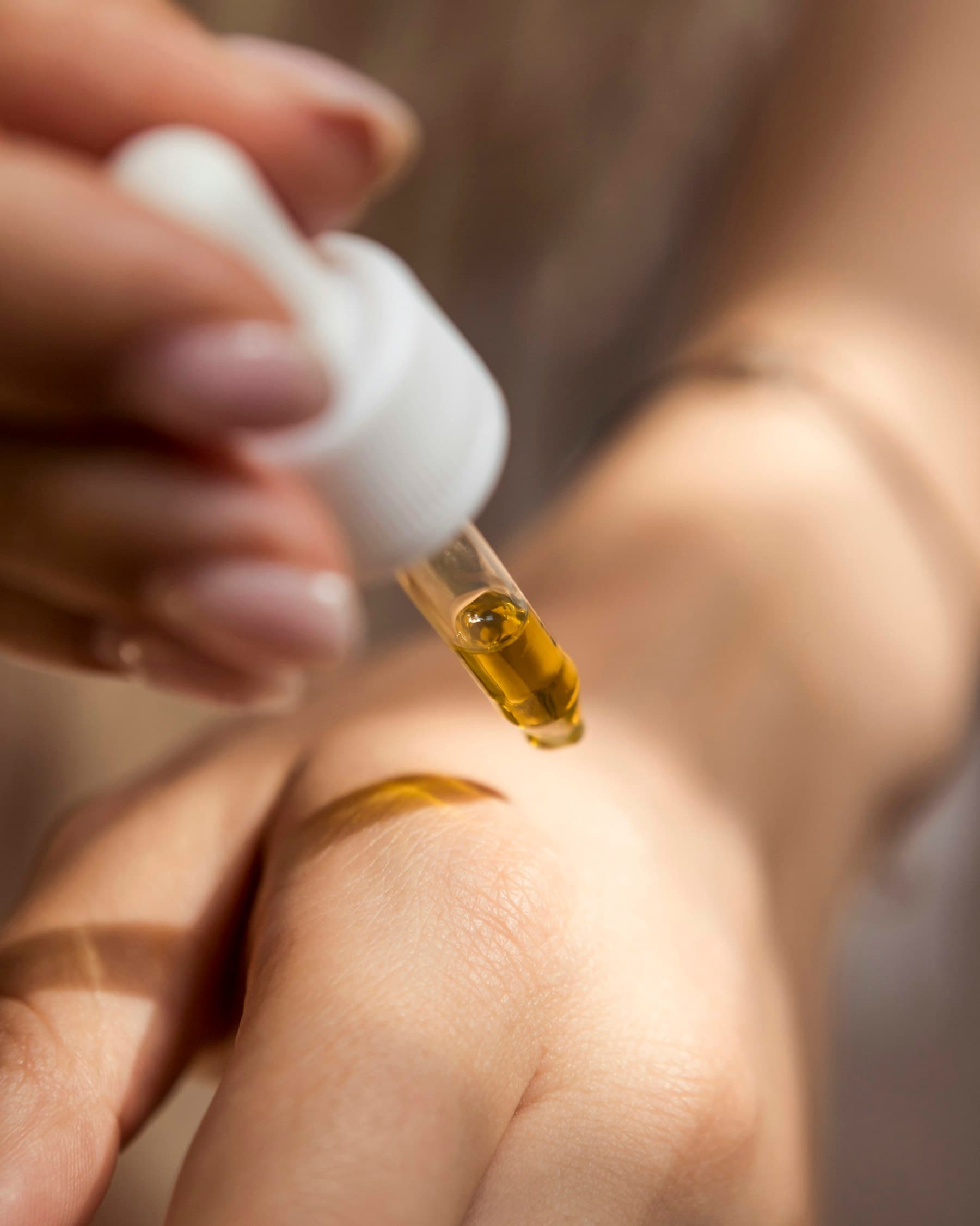 A drop of oil on the back of a hand